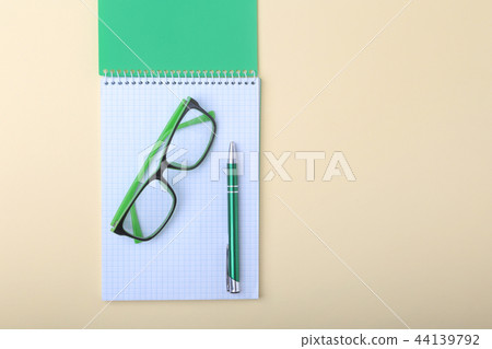 Business accessories on desktop: notebook, diary, fountain pen, glasses. Macro with blur and soft 44139792