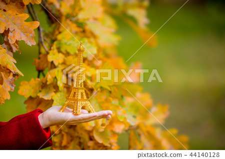 female hand holding an Eiffel tower toy female hand holding an Eiffel tower toy 44140128
