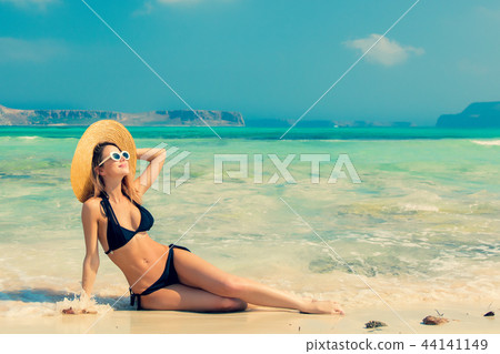 girl in black bikini and with hat on Balos beach 44141149