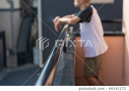 Men, smoking, veranda Men, smoking, veranda 44141172