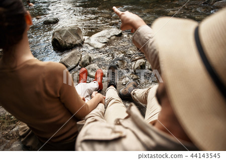 Young man pointing to the distance and showing the view to his girlfriend 44143545