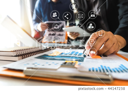 two colleagues discussing data working in the offi 44147238