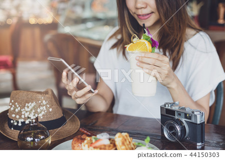 Young woman using smart phone Young woman using smart phone 44150303