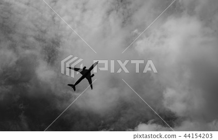 Commercial airplane on grey sky and clouds 44154203