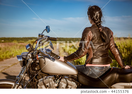 Biker girl sitting on motorcycle Biker girl sitting on motorcycle 44155376