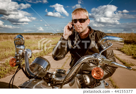 Biker talking on a smartphone. Biker talking on a smartphone. 44155377