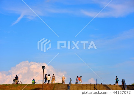 People watching surfers on Sagami River embankment People watching surfers on Sagami River embankment 44157072