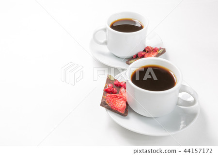Two cups of coffee and hand-made chocolate Two cups of coffee and hand-made chocolate 44157172