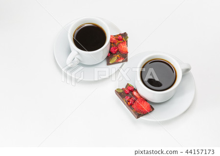 Two cups of coffee and hand-made chocolate Two cups of coffee and hand-made chocolate 44157173