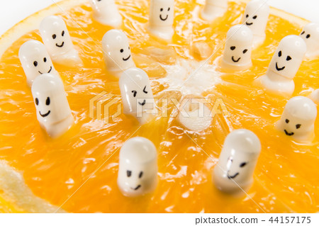 Funny capsules with vitamins from half an orange. Funny capsules with vitamins from half an orange. 44157175