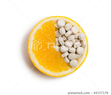 Tablets with vitamins in an orange slice. Tablets with vitamins in an orange slice. 44157176
