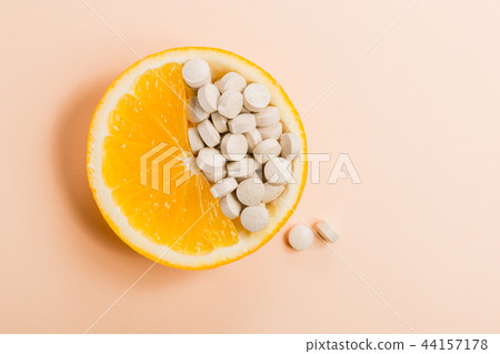 Tablets with vitamins in an orange slice on Tablets with vitamins in an orange slice on 44157178