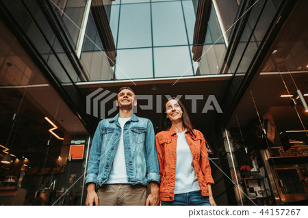 Happy man keeping hand of beaming girl 44157267