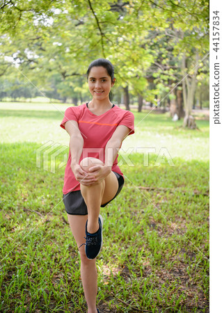 Exercise concept. Beautiful girl is stretching her muscles. Beau Exercise concept. Beautiful girl is stretching her muscles. Beau 44157834