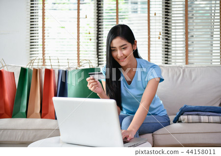 shopping online concept. Beautiful girls are buying clothes onli shopping online concept. Beautiful girls are buying clothes onli 44158011
