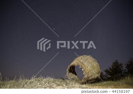 Old wicker basket with startrail in the background 44158197