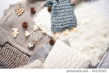 Warm clothes situating on floor on carpet Warm clothes situating on floor on carpet 44158385