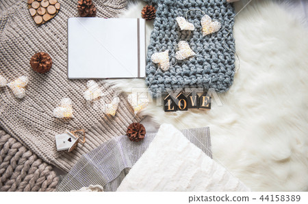 Sweater scarf and garland locating on carpet Sweater scarf and garland locating on carpet 44158389
