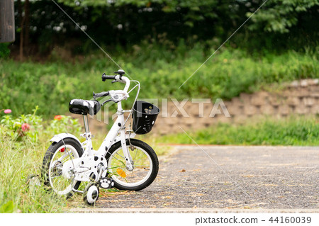 Children's four-wheeled bicycle parked in the park 44160039