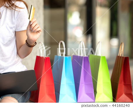 Credit card in hand shoppinggirl with shopping bag Credit card in hand shoppinggirl with shopping bag 44160240