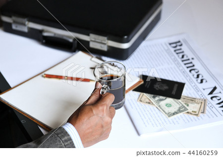 businessman holding coffee with business newpaper. 44160259