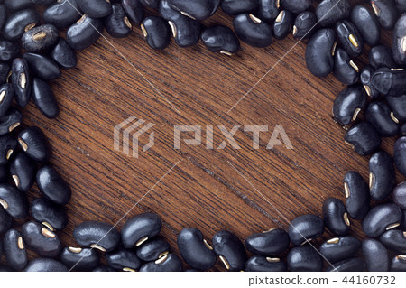 black bean on wooden table. top view. black bean on wooden table. top view. 44160732