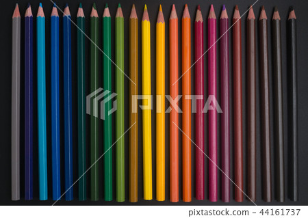 color pencils on black background close up.. color pencils on black background close up.. 44161737