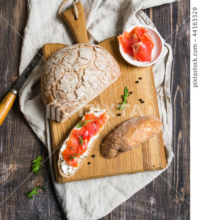Toast with smoked salmon and cream cheese on board Toast with smoked salmon and cream cheese on board 44163329