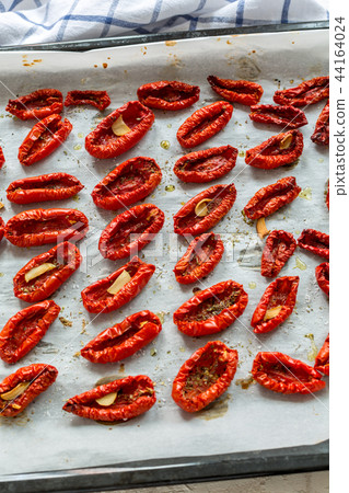 Sun-dried tomatoes with spices and olive oil. Sun-dried tomatoes with spices and olive oil. 44164024