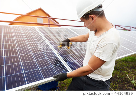 Installation of stand-alone exterior photo voltaic panels system. Renewable green energy generation. Installation of stand-alone exterior photo voltaic panels system. Renewable green energy generation. 44164959