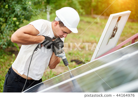 Installation of stand-alone exterior photo voltaic panels system. Renewable green energy generation. Installation of stand-alone exterior photo voltaic panels system. Renewable green energy generation. 44164976