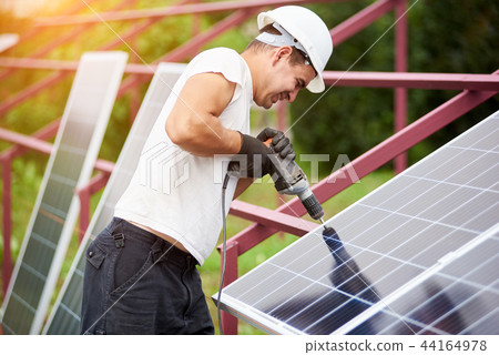 Installation of stand-alone exterior photo voltaic panels system. Renewable green energy generation. Installation of stand-alone exterior photo voltaic panels system. Renewable green energy generation. 44164978
