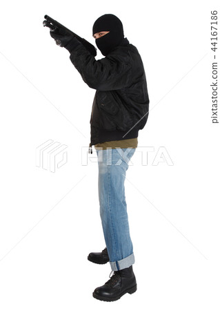 mobster in black mask with shotgun 44167186