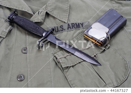 M16 rifle bayonet on uniform bacground 44167327