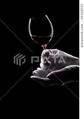 Contours of hands in white gloves hold wine glass Contours of hands in white gloves hold wine glass 44168035