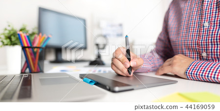 Graphic designer working on digital tablet Graphic designer working on digital tablet 44169059