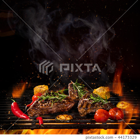 Beef steaks on the grill with flames 44173329