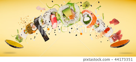 Pieces of delicious japanese sushi frozen in the air. Pieces of delicious japanese sushi frozen in the air. 44173351