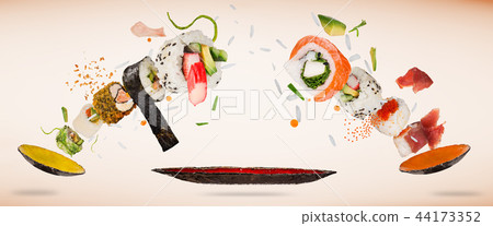 Pieces of delicious japanese sushi frozen in the air. Pieces of delicious japanese sushi frozen in the air. 44173352
