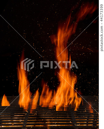 Empty flaming charcoal grill with open fire. Empty flaming charcoal grill with open fire. 44173399
