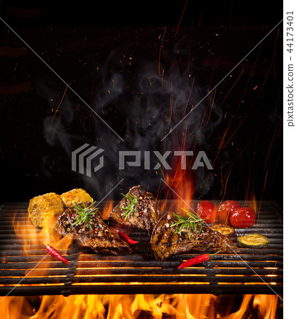 Beef steaks on the grill with flames 44173401