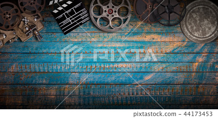 Cinema concept of vintage film reels, clapperboard and projector. Cinema concept of vintage film reels, clapperboard and projector. 44173453