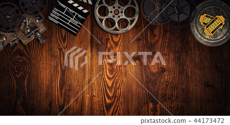 Cinema concept of vintage film reels, clapperboard and projector. 44173472
