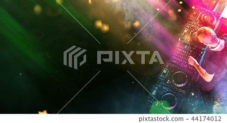 Dj mixes the track in the nightclub at a party Dj mixes the track in the nightclub at a party 44174012