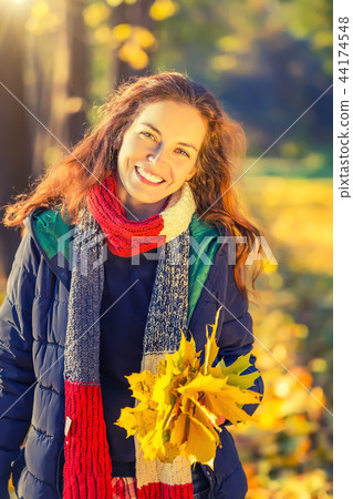 Portrait of young beautiful woman in autumn park 44174548