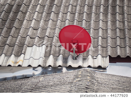 Red satellite dish is attached on top of roof. 44177920
