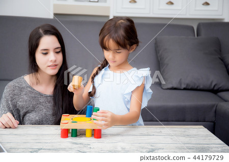 Mother and child play toy together Mother and child play toy together 44179729