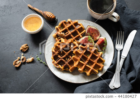 Whole wheat waffles with honey and cup of coffee Whole wheat waffles with honey and cup of coffee 44180427