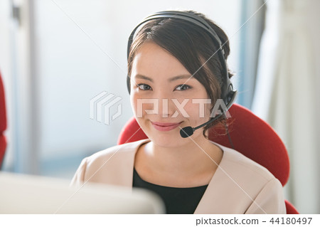 A young woman of an operator who talks on income A young woman of an operator who talks on income 44180497