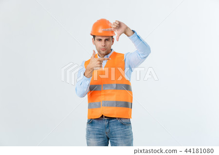 Young handsome architec man with wearing safety helmet over isolated background making frame with 44181080